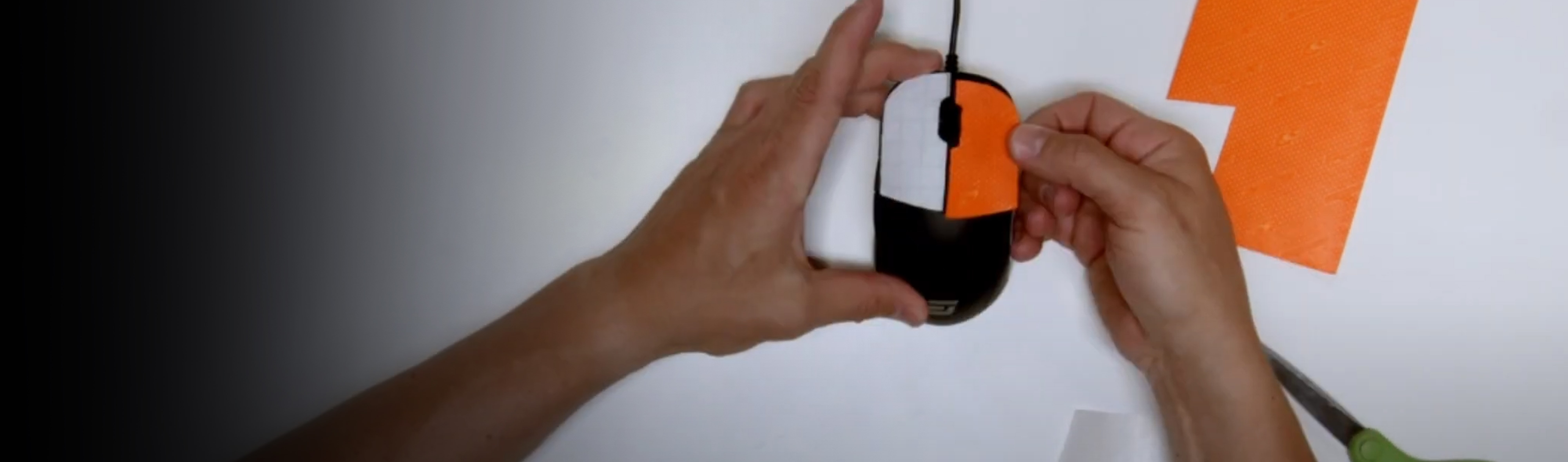 Hands applying mouse grip to a computer mouse