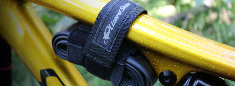 black bike utility strap on a yellow bike frame